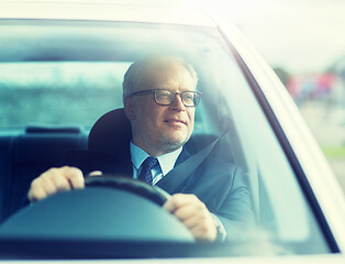 Image showing happy senior businessman driving car