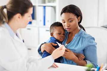Image showing mother with sick baby son and doctor at clinic
