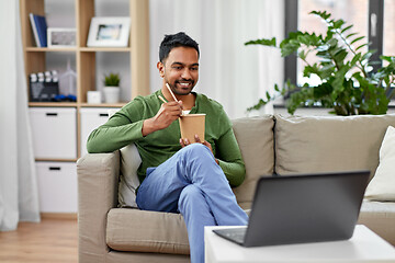 Image showing indian man with laptop eating takeout food at home