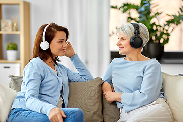 Image showing senior mother and adult daughter with headphones