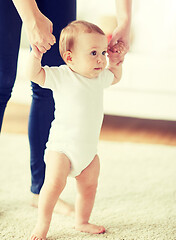 Image showing happy baby learning to walk with mother help