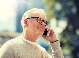 Image showing happy senior man calling on smartphone in city