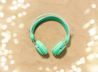 Image showing earphones on summer beach sand