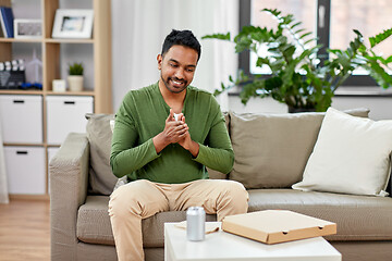 Image showing indian man with takeaway pizza box at home