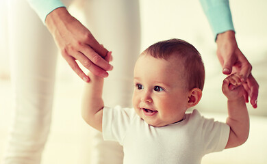 Image showing happy baby learning to walk with mother help