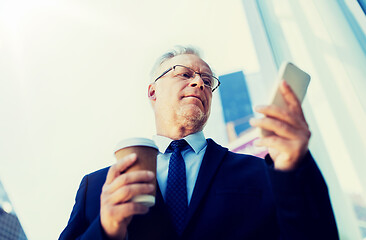 Image showing businessman with smartphone and coffee in city