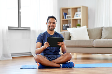 Image showing indian man with tablet pc and exercise mat at home