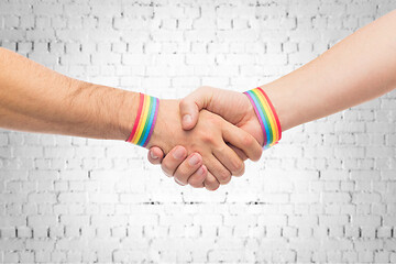 Image showing hands with gay pride wristbands make handshake