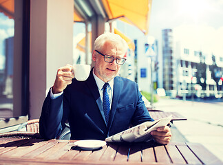 Image showing senior businessman with newspaper drinking coffee