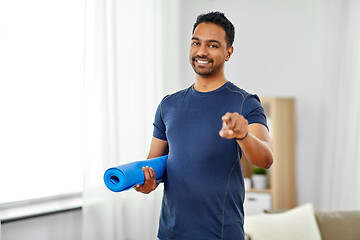 Image showing smiling indian man with exercise mat at home