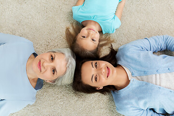 Image showing mother, daughter and grandmother lying on floor