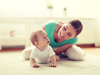 Image showing happy mother playing with baby at home