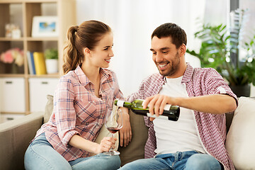 Image showing happy couple drinking red wine at home