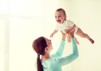 Image showing happy young mother with little baby at home