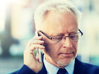 Image showing close up of old businessman calling on smartphone