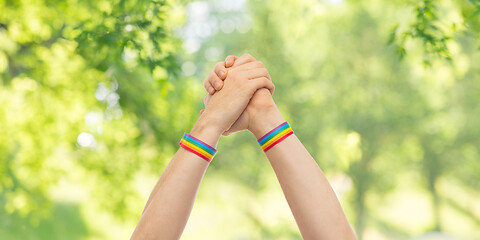 Image showing hands with gay pride wristbands in winning gesture