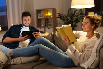 Image showing couple with tablet computer and book at home