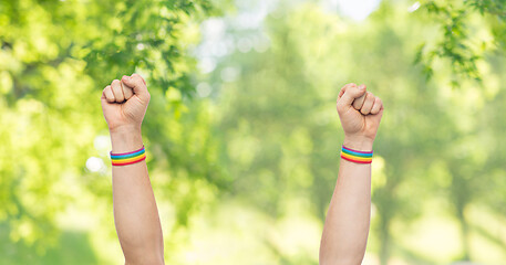 Image showing hands with gay pride rainbow wristbands shows fist