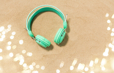 Image showing earphones on summer beach sand