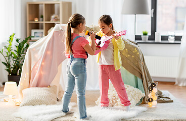 Image showing girls with guitar and microphone playing at home