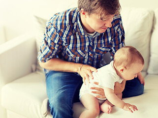 Image showing happy young father with little baby at home