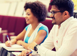 Image showing international students with notebooks on lecture