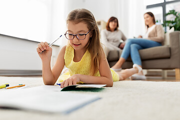 Image showing student girl writing to notebook at home