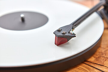 Image showing Old-fashioned turnable record player on a wooden background.