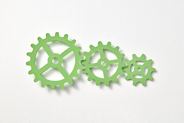 Image showing Clockwork mechanism handmade from paper on a white background.