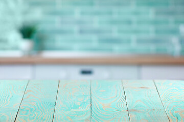 Image showing Wooden textured blue table on a background of blurred interior.