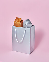 Image showing Mock-up silver paper bag with two milk packages on a pink background.