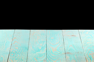 Image showing Blank blue wooden textured table on a black background.