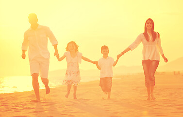 Image showing happy young family have fun on beach at sunset