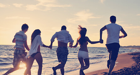 Image showing people group running on the beach