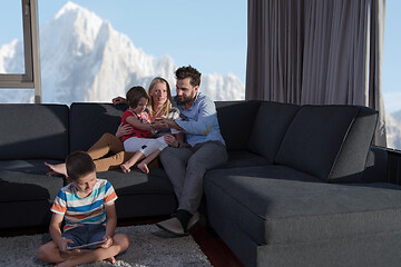 Image showing happy young couple spending time with kids at home