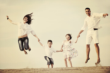 Image showing happy young family have fun on beach