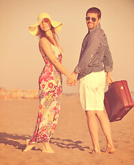 Image showing couple on beach with travel bag