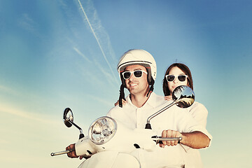 Image showing Portrait of happy young love couple on scooter enjoying summer t