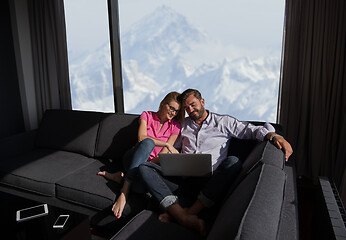 Image showing couple relaxing at  home using laptop computers