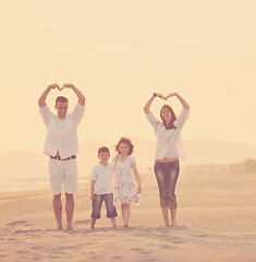 Image showing happy young family have fun on beach at sunset