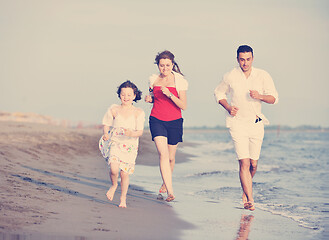 Image showing happy young family have fun on beach