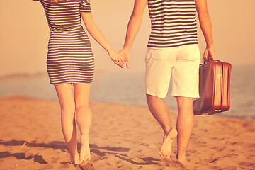 Image showing couple on beach with travel bag