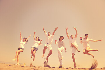 Image showing happy people group have fun and running on beach