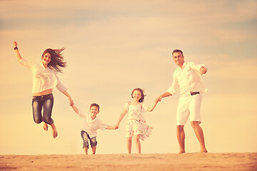 Image showing happy young family have fun on beach