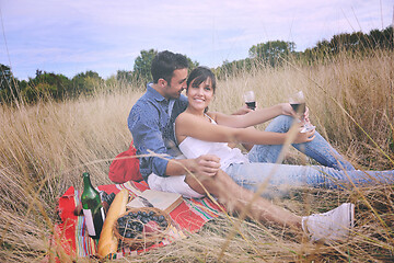 Image showing happy couple enjoying countryside picnic in long grass