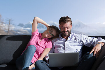 Image showing couple relaxing at  home using laptop computers