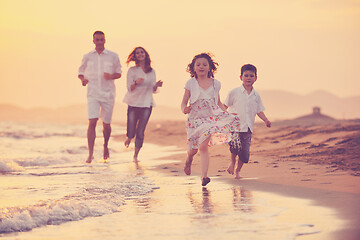 Image showing happy young family have fun on beach at sunset