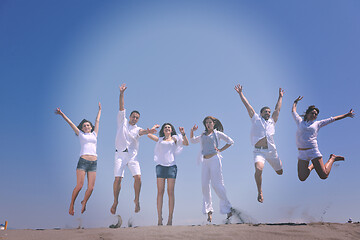 Image showing happy people group have fun and running on beach