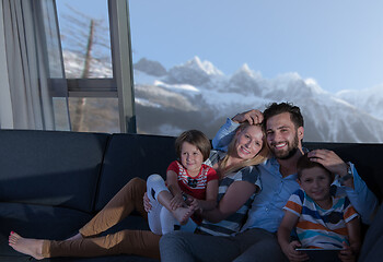 Image showing happy young couple spending time with kids at home