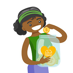 Image showing Woman saving money in glass jar to buy a house.